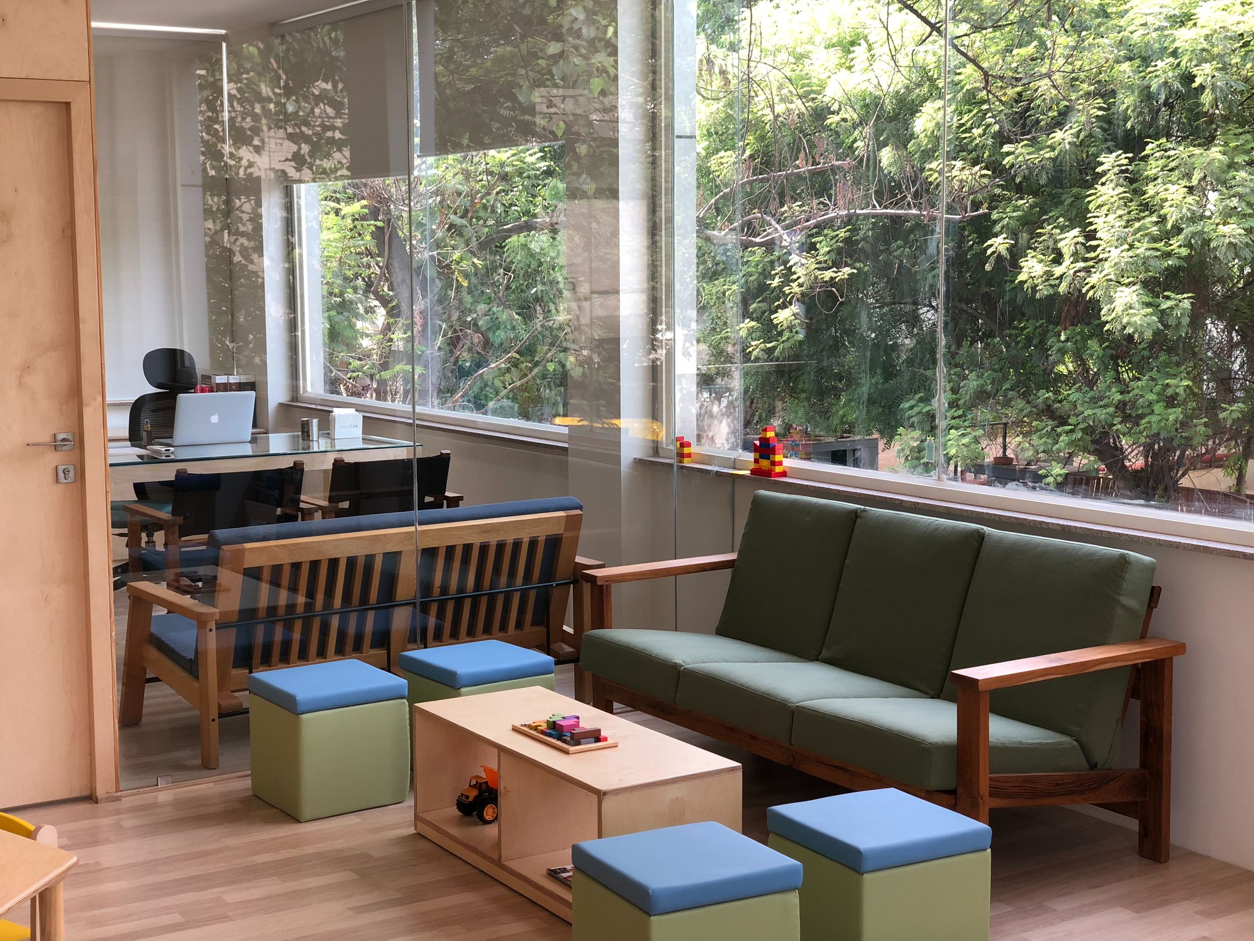 Doctors office waiting room with bright furniture and large windows
