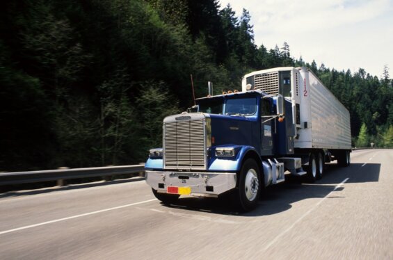 Semi truck moves along freeway