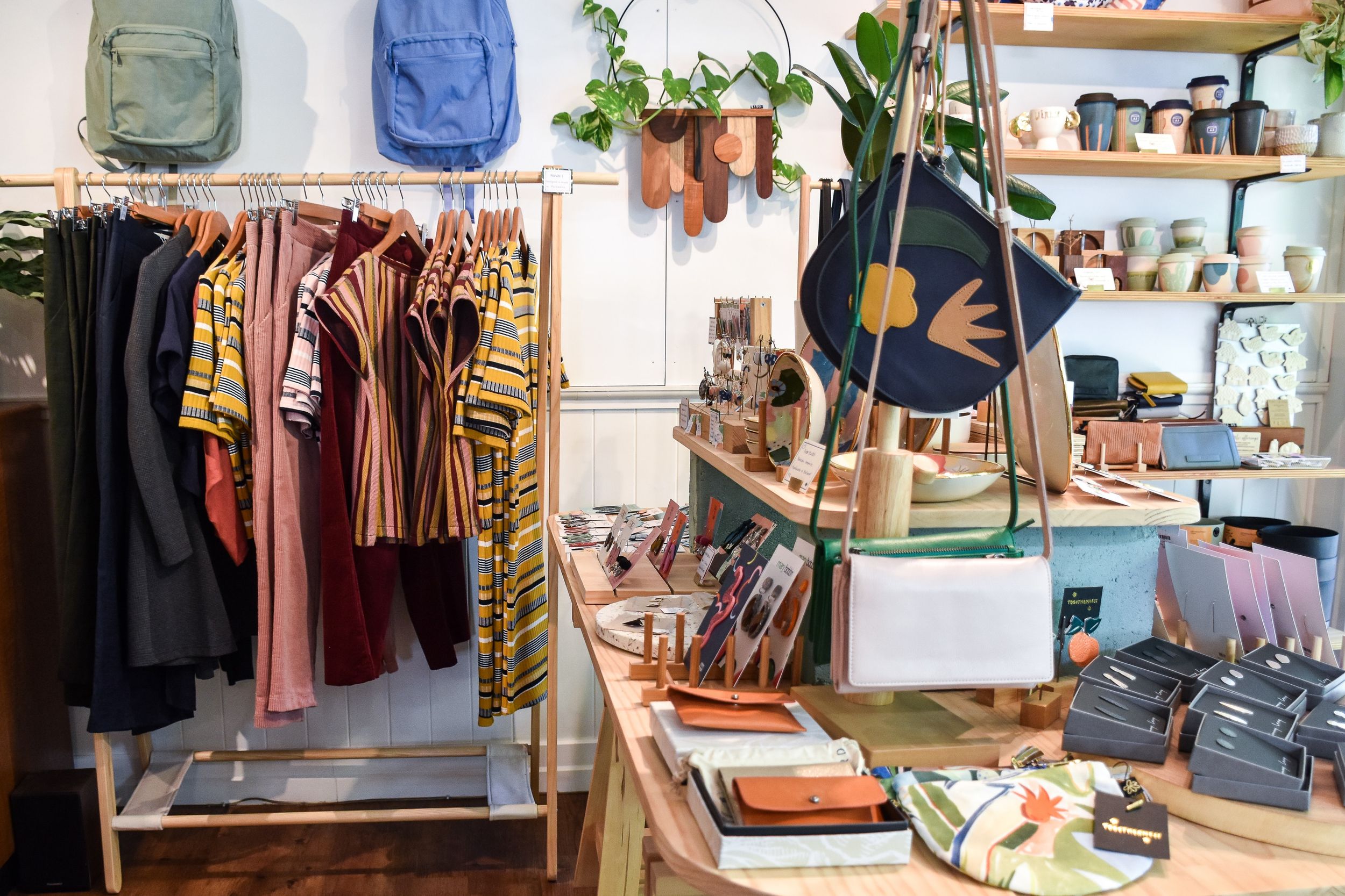 Small clothing store filled with vibrant textiles and art