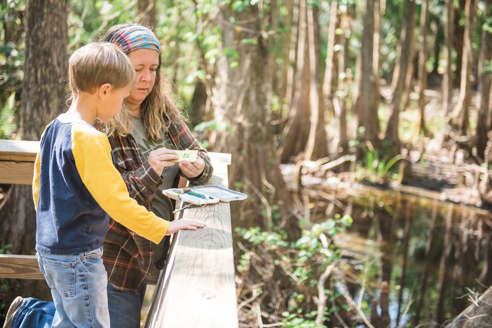 Woman and young boy look over railing at Highlands Hammock State Park